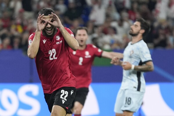  Georgia's Georges Mikautadze celebrates after scoring on a penalty kick during a Group F match between Georgia and Portugal at the Euro 2024 soccer tournament in Gelsenkirchen, Germany, Wednesday, June 26, 2024. (AP Photo/Martin Meissner)