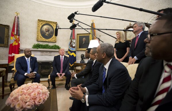 
              FILE - In this Feb. 14, 2018, file photo, President Donald Trump, with Sen. Tim Scott, R-S.C., left, Ivanka Trump, top second from right, and Steve Case, top right, participate in a working session regarding the opportunity zones provided by tax reform in the Oval Office of the White House in Washington. An Associated Press investigation found Trump’s daughter and son-in law stand to benefit from a program they pushed that offers massive tax breaks to developers who invest in downtrodden American areas. (AP Photo/Manuel Balce Ceneta, File)
            