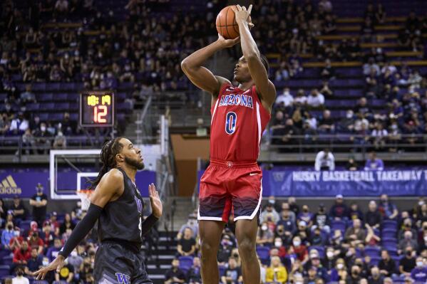 Arizona's Bennedict Mathurin shoots over Washington's PJ Fuller during the first half of an NCAA college basketball game Saturday, Feb. 12, 2022, in Seattle. (AP Photo/John Froschauer)