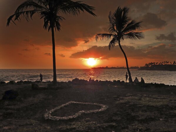 
              In this May 23, 2018, photo provided by Chris Stewart the sun sets through “vog,” or volcanic smog, in Kailua-Kona, Hawaii. Kilauea volcano on Hawaii’s Big Island has had it all over the past three weeks: molten rock shooting toward the sky, lava oozing from the ground and ash clouds rising miles into the air. You can also add “vog” to the mix. Retired photojournalist Chris Stewart says there’s one good thing about vog: It intensifies the colors of a sunset. But it depends on how thick the haze is. “Some days it’s thin enough you can see the sun passing through,” he said. “But other days we just go inside because we can’t see it at all.” (Chris Stewart via AP)
            