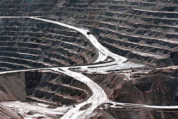 FILE - Terraces cut into the hillside at the huge Santa Rita copper mine in Grant County, N.M., are shown in this March 1999 file photo. The Biden administration is recommending changes to a 151-year-old law that governs mining for copper, gold and other hardrock minerals on U.S.-owned lands, including making companies pay royalties on what they extract. (Richard Pipes/The Albuquerque Journal via AP, File)