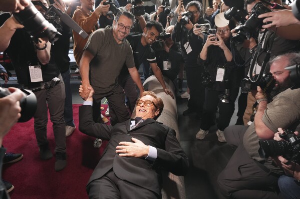 Conan O'Brien, host of Sunday's 97th Academy Awards, poses atop the red carpet during the annual red carpet roll out at the Dolby Theatre on Wednesday, Feb. 26, 2025, in Los Angeles. (AP Photo/Chris Pizzello)