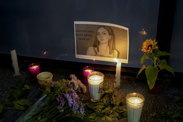 FILE - Candles and flowers surround an image of Debanhi Escobar, an 18-year-old who was found dead in a motel's water tank days after getting out of a taxi on a dark highway near the northern city of Monterrey, during a protest against Escobar's disappearance and other women who have gone missing at the Attorney General's office in Mexico City, April 22, 2022. The most reliable count shows that homicides in Mexico declined significantly for the first time in several years in 2022, Mexico’s National Statistics Institute said Tuesday, July 25, 2023. (AP Photo/Eduardo Verdugo, File)
