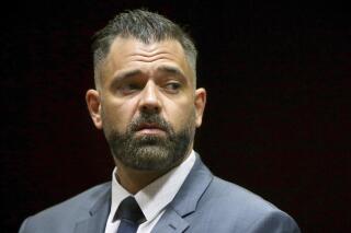 FILE - In this May 28, 2019, photo, Mark D'Amico stands during his arraignment to charges including theft by deception at Burlington County Superior Court in Mount Holly, N.J. D'Amico, who conspired with his former girlfriend to cook up a feel-good story about a helpful homeless man and then used the lie to raise hundreds of thousands of dollars in donations online has been sentenced in federal court. D’Amico received a 27-month term on Friday, April 1, 2022. (Tim Tai/The Philadelphia Inquirer via AP, Pool, File)