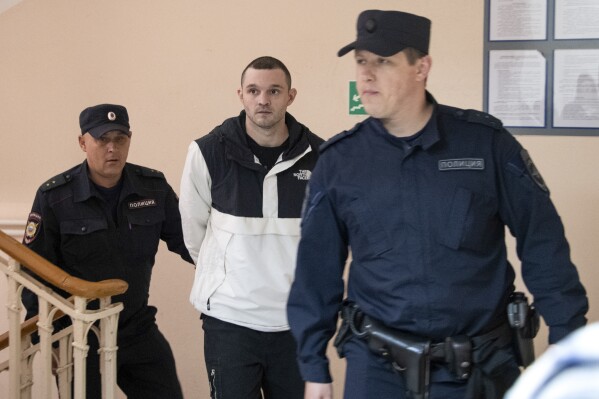 U.S. Army Staff Sgt. Gordon Black is escorted to a courtroom in Vladivostok, Russia, Thursday, June 6, 2024. A court in Russia's far eastern city of Vladivostok on Thursday began the trial of an American soldier arrested in the city earlier this year on charges of stealing. He faces up to five years in prison if convicted. (AP Photo/)