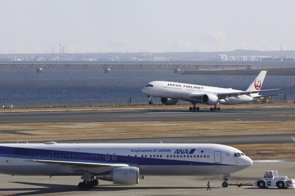 A Japan Airlines plane takes off from the runway at Haneda airport in Tokyo Monday, Jan. 8, 2024. Tokyo’s Haneda airport is almost back to its normal operation Monday as it reopened the runway a week after a fatal collision between a Japan Airlines airliner and a coast guard aircraft seen to have been caused by human error. (Kyodo News via AP)