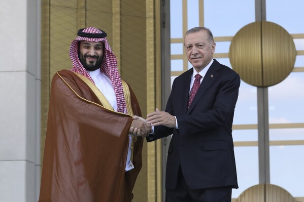 FILE - Turkish President Recep Tayyip Erdogan, right, and Saudi Crown Prince Mohammed bin Salman shake hands during a welcome ceremony, in Ankara, Turkey, Wednesday, June 22, 2022. Erdogan is beginning a three-stop tour of Gulf states to raise trade and investment for Turkey’s floundering economy. The president will arrive in Jeddah, Saudi Arabia, on Monday, July 17, 2023, accompanied by an entourage of some 200 businesspeople. Business forums have been arranged in Saudi Arabia, Qatar and the United Arab Emirate. (AP Photo/Burhan Ozbilici, File)