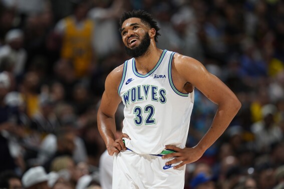 Minnesota Timberwolves center Karl-Anthony Towns reacts after being called for a foul in the second half of Game 7 of an NBA second-round playoff series against the Denver Nuggets Sunday, May 19, 2024, in Denver. (AP Photo/David Zalubowski)