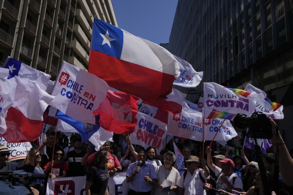 People against the proposed draft of a new Constitution attend a closing campaign in Santiago, Chile, Thursday, Dec. 14, 2023. Chileans have until Dec. 17th to study the articles and decide whether it will replace the current constitution, imposed by the military dictatorship 41 years ago, or if they prefer another path to change. (AP Photo/Esteban Felix)