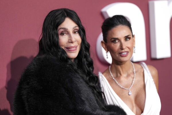 Demi Moore, left, and Cher pose for photographers upon arrival at the amfAR Cinema Against AIDS benefit at the Hotel du Cap-Eden-Roc, during the 77th Cannes international film festival, Cap d'Antibes, southern France, Thursday, May 23, 2024. (Photo by Scott A Garfitt/Invision/AP)