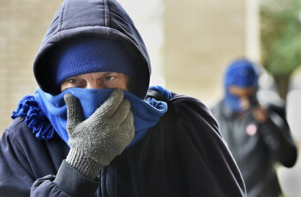 
              Chris McGuire tries to stay warm as he waits for a space at the City Rescue Mission on Tuesday, Jan. 2, 2018, in Jacksonville, Fla. Dangerously cold temperatures blamed for several deaths have wreaked havoc across a wide swath of the U.S., freezing a water tower in Iowa, halting ferry service in New York and leading officials to open warming centers even in the Deep South. (Will Dickey/The Florida Times-Union via AP)
            