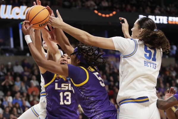 LSU guard Last-Tear Poa (13), forward Sa'Myah Smith (5) and UCLA center Lauren Betts (51) go after a rebound during the second half in the Elite Eight of the NCAA college basketball tournament, Sunday, March 30, 2025, in Spokane, Wash. (AP Photo/Young Kwak)