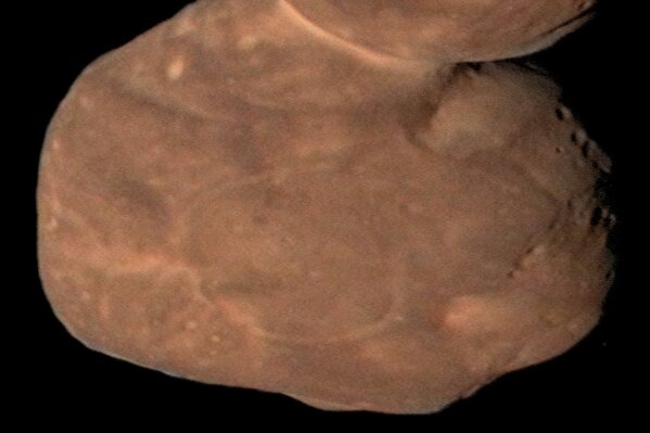 This Jan. 1, 2019 image from NASA shows Arrokoth, the farthest, most primitive object in the Solar System ever to be visited by a spacecraft. Astronomers reported Thursday, Feb. 13, 2020 that this pristine, primordial cosmic body photographed by the New Horizons probe is relatively smooth with far fewer craters than expected. It's also entirely ultrared, or highly reflective, which is commonplace in the faraway Twilight Zone of our solar system known as the the Kuiper Belt. (NASA/Johns Hopkins University Applied Physics Laboratory/Southwest Research Institute/Roman Tkachenko via AP)