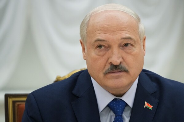 FILE - Belarusian President Alexander Lukashenko listens, during his meeting with foreign correspondents, in Minsk, Belarus, on July 6, 2023. A former member of Lukashenko’s special security forces is set to face trial in Switzerland next month for the forced disappearances of political opponents in the late 1990s, according to human rights and victims advocacy groups Wednesday Aug. 30, 2023. (AP Photo/Alexander Zemlianichenko, File)