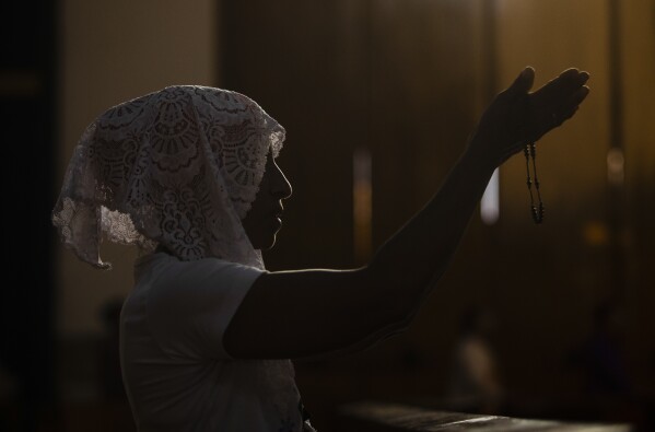 FILE - A woman prays during a reenactment of the Stations of the Cross during the Lenten season at the Metropolitan Cathedral in Managua, Nicaragua, Friday, March 17, 2023. Amid tensions between the Vatican and the Daniel Ortega government, Catholics staged the devotional commemoration of Jesus Christ's last day on Earth in the gardens of the Cathedral due to the police ban on celebrating religious festivities on the streets. (AP Photo/Inti Ocon, File)