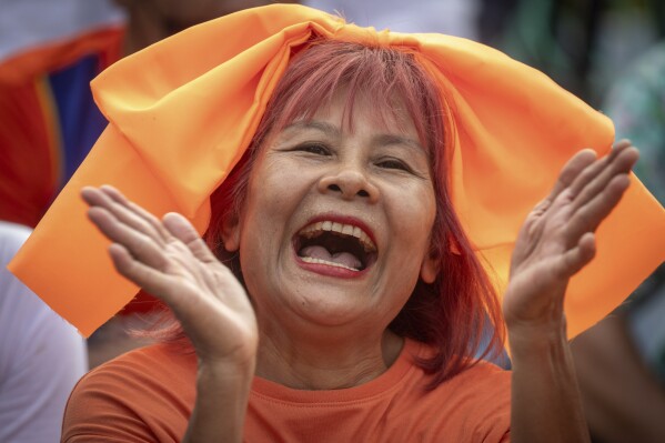 Supporters of Move Forward Party shout outside parliament during vote counting, in Bangkok, Thailand, Thursday, July 13, 2023. Pita, whose Move Forward Party ran first in Thailand's May 14 general election, was nominated to be prime minister at a joint session of Parliament's Upper and Lower House on Thursday, but failed to attain the majority vote needed to win the job, necessitating a new round of voting expected next week. (AP Photo/Wason Wanichakorn)