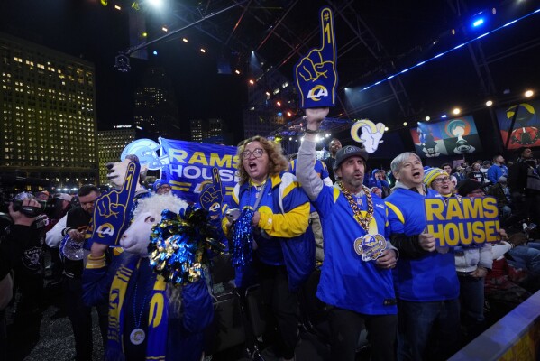 Los Angeles Rams fans cheer during the first round of the NFL football draft, Thursday, April 25, 2024, in Detroit. (AP Photo/Paul Sancya)