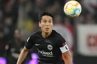 FILE - Frankfurt's Makoto Hasebe plays during the German Bundesliga soccer match between 1.FC Cologne and Eintracht Frankfurt in Cologne, Germany, on Feb. 12, 2023. Frankfurt said Tuesday March 21, 2023 that the 39-year-old Hasebe has a new contract with the club to 2027 and that he’ll take on a coaching role whenever he finally decides to quit as a player. (AP Photo/Martin Meissner, File)
