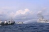 In this handout photo provided by the Philippine Coast Guard, a Chinese Coast Guard ship uses water cannons on Philippine navy-operated supply boat M/L Kalayaan as it approaches Second Thomas Shoal, locally known as Ayungin Shoal, in the disputed South China Sea on Sunday Dec. 10, 2023. The Chinese coast guard targeted Philippine vessels with water cannon blasts Sunday and rammed one of them, causing damage and endangering Filipino crew members off a disputed shoal in the South China Sea, just a day after similar hostilities at another contested shoal, Philippine officials said.(Philippine Coast Guard via AP)