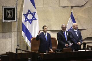 Israel's President-elect Isaac Herzog, left, Speaker of the Knesset, Mickey Levi, center, and Israel's outgoing President Reuven Rivlin during his sworn ceremony in the Knesset in Jerusalem, Wednesday, July 7, 2021. (AP Photo/Sebastian Scheiner)