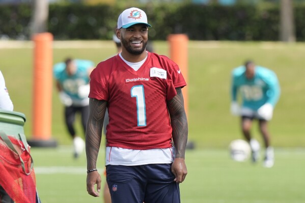 Miami Dolphins quarterback Tua Tagovailoa (1) smiles during a practice session at the team's training facility, Wednesday, Oct. 23, 2024, in Miami Gardens, Fla. (AP Photo/Marta Lavandier)