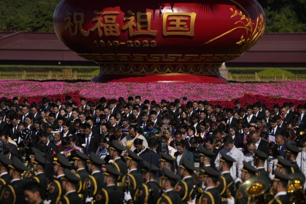 Participants bow to pay respects to the People's Heroes Monument during a ceremony to mark Martyr's Day at Tiananmen Square in Beijing, Saturday, Sept. 30, 2023. (AP Photo/Andy Wong)