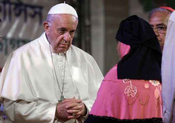 Pope Francis meets Rohingya Muslims refugees from Myanmar during an interfaith and ecumenical meeting for peace in the garden of the archbishop’s residence, in Dhaka, Bangladesh, Dec. 1, 2017. (AP Photo/Andrew Medichini)