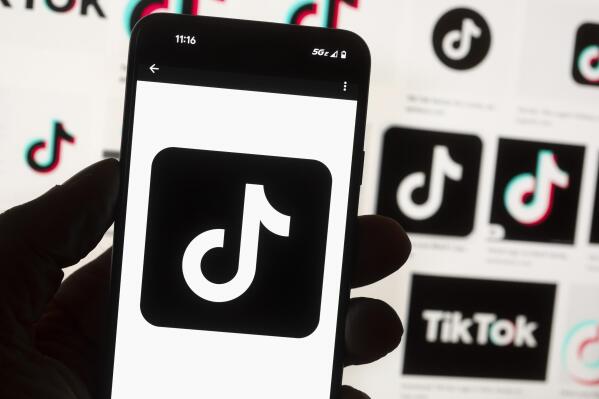 FILE - The TikTok logo is seen on a cell phone on Oct. 14, 2022, in Boston. Georgia Gov. Brian Kemp on Thursday, Dec. 15, 2022, immediately banned the use of TikTok and two popular messaging applications from all computer devices controlled by Georgia's state government, saying the Chinese government may be able to access users' personal information. (AP Photo/Michael Dwyer, File)