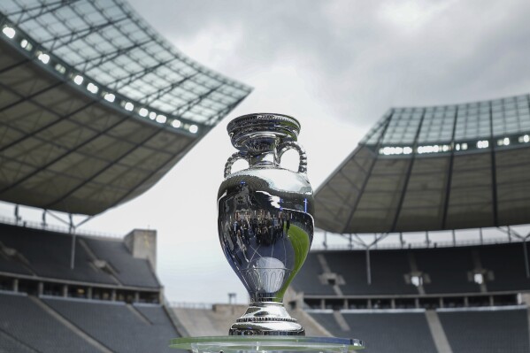 FILE - The trophy is on display during the presentation of the European soccer championship 'EURO 2024' trophy at the Olympic Stadium in Berlin, Germany, Wednesday, April 24, 2024. The European Championship in Germany is all about tried and tested stadiums with a rich soccer history. Unlike at some recent World Cups, there's been no rush to finish stadiums on time. (AP Photo/Markus Schreiber, File)