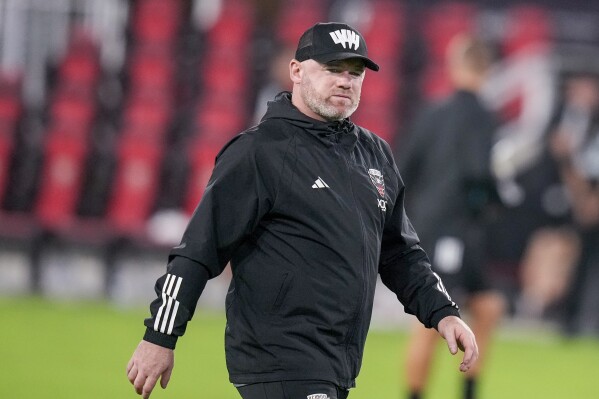 FILE - D.C. United head coach Wayne Rooney walks off the field after the team's MLS soccer match against Inter Miami, July 8, 2023, in Washington. Rooney is out as coach of D.C. United after one season, the team said. Despite the club falling short of the 2023 MLS Cup Playoffs, Rooney improved D.C. United’s point tally in his only full season at the helm. (AP Photo/Alex Brandon, File)