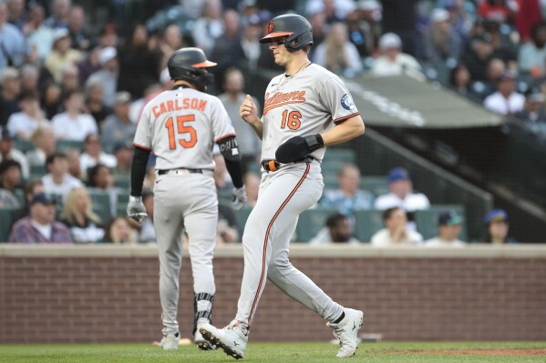 Baltimore Orioles' Coby Mayo (16) scores on a two-RBI triple by Heston Kjerstad during the seventh inning of a baseball game against the Seattle Mariners, Wednesday, June 4, 2025, in Seattle. (AP Photo/Jason Redmond)