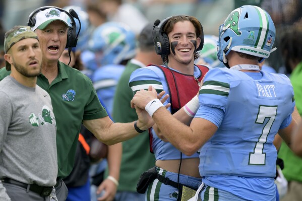 Tulane head coach Willie Fritz, second left, celebrates a touchdown thrown by Tulane quarterback Michael Pratt (7) during the first half of an NCAA college football game against Tulsa in New Orleans, Saturday, Nov. 11, 2023. (AP Photo/Matthew Hinton)