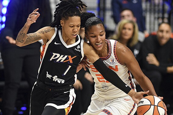 Phoenix Mercury's Sug Sutton (1) steals a ball from Connecticut Sun's Alyssa Thomas (25) during a WNBA basketball game in Uncasville, Conn., Thursday, Aug. 31, 2023. (Sarah Gordon/The Day via AP)