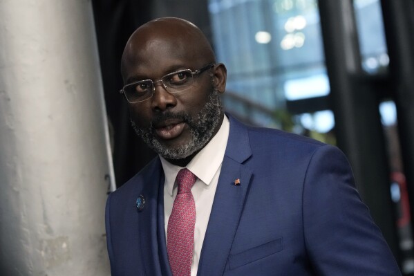 FILE - Liberia President George Weah arrives to attend the Paris Peace Forum, in Paris, France, Nov. 11, 2021. Liberia's presidential election Wednesday, Oct. 18, 2023 appeared headed for a run-off with the top candidates neck and neck and the votes nearly fully counted. President George Weah, who is seeking a second term, had 43.8% of the vote with his main challenger Joseph Boakai at 43.4%, according to the National Elections Commission. A candidate needs more than 50% of the vote to win. (AP Photo/Christophe Ena, File)