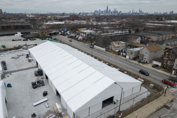 FILE - Construction of a government-run tent encampment for migrants is underway, Monday Dec. 4, 2023, in the Brighton Park neighborhood of Chicago. Gov. J.B. Pritzker’s administration on Tuesday, Dec. 5 announced it is scrapping construction of the temporary winter camp for migrants, citing the risk of contaminants at the former industrial site. (AP Photo/Erin Hooley, file)