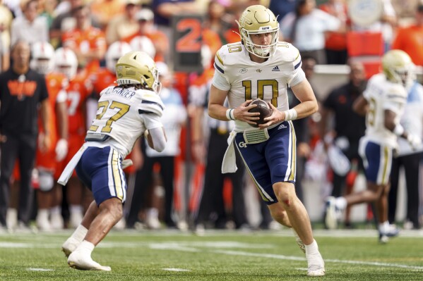 Georgia Tech quarterback Haynes King (10) drops back during the first half of an NCAA college football game against Miami, Saturday, Nov. 9, 2024, in Atlanta. (AP Photo/Jason Allen)