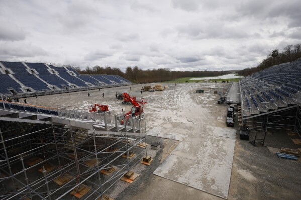 The track for the equestrian sports is under construction Friday, March 29, 2024 in the park of the Chateau de Versailles, west of Paris. The site will be the venue for equestrian sports at the Paris 2024 Olympic Games. (AP Photo/Thomas Padilla)