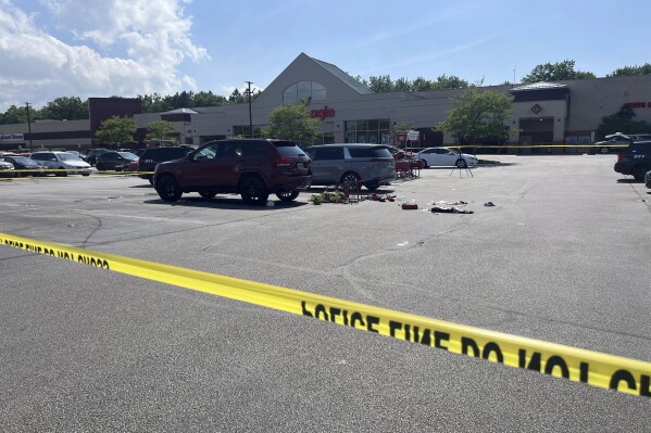 Crime scene tape is seen, Monday, June 3, 2024, where a 3-year-old boy was fatally stabbed by a woman as he sat in a grocery cart in this Giant Eagle supermarket parking lot in North Olmsted, Ohio. Investigators said Tuesday, June 4, that they believe it was a random attack. (Hannah Drown/Cleveland.com via AP)