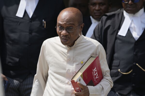 Godwin Emefiele, suspended Central Bank governor, leaves after a court hearing at the Federal High Court in Lagos Nigeria, Tuesday, July 25, 2023. Nigeria's suspended Central Bank governor appeared in court on Tuesday in the economic hub of Lagos on charges of illegal possession of a firearm and live ammunition. (AP Photo/Sunday Alamba)