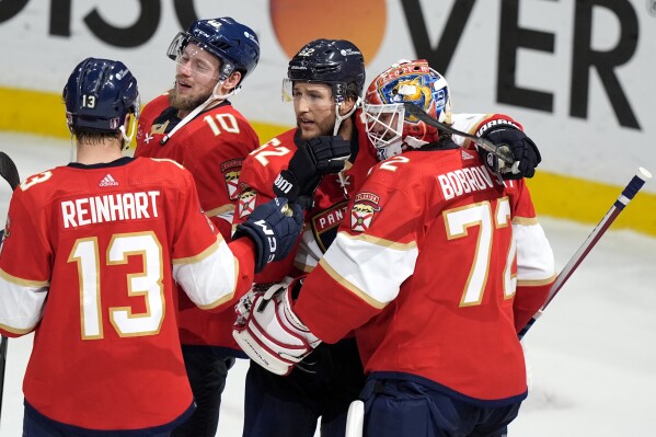 Florida Panthers center Sam Reinhart (13), right wing Vladimir Tarasenko (10), defenseman Brandon Montour, second from right, and goaltender Sergei Bobrovsky (72) celebrates after defeating the New York Rangers in Game 6 to win the Eastern Conference finals of the NHL hockey Stanley Cup playoffs Saturday, June 1, 2024, in Sunrise, Fla. (AP Photo/Lynne Sladky)