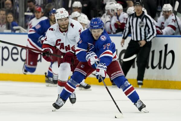 New York Rangers center Frank Vatrano (77) breaks away from Carolina Hurricanes defenseman Brett Pesce (22) in the second period of Game 4 of an NHL hockey Stanley Cup second-round playoff series, Tuesday, May 24, 2022, in New York. (AP Photo/John Minchillo)