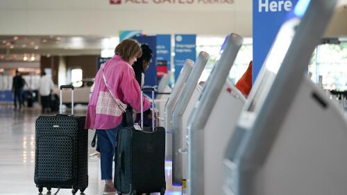 FILE - Travelers use the kiosk by the ticketing gate as they prepare for travel from Love Field airport, May 19, 2023, in Dallas. Lawmakers are considering rolling back an Obama-era rule that requires airlines to show the total price of a ticket upfront in advertising, while also tweaking training requirements for airline pilots and making other changes in a massive bill covering the Federal Aviation Administration. (AP Photo/Tony Gutierrez, File)