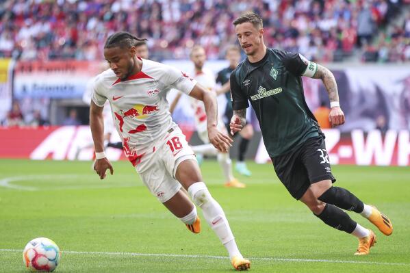 Leipzig's Christopher Nkunku, left, and Bremen's Marco Friedl, right, challenge for the ball during the German Bundesliga soccer match between RB Leipzig and SV Werder Bremen in Leipzig, Germany, Sunday, May 14, 2023. (Jan Woitas/dpa via AP)