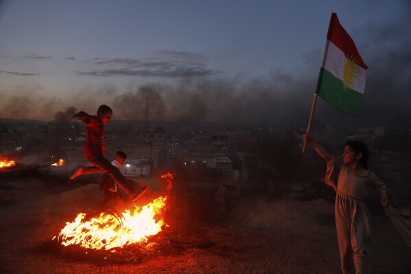 Syrian Kurds celebrate their Nowruz, Kurdish New Year in Amuda, Hasaka region, northeastern Syria, Thursday March 20, 2025. (AP Photo/Baderkhan Ahmad)
