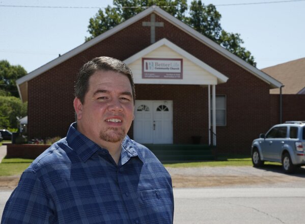 
              Pastor Danny Daniels poses for a photo in front of his Better Life Community Church in Lindsay, Okla., Friday, June 15, 2018. Daniels is among a growing group of traditionally conservative Republican voters who have shifted their position in favor of medical marijuana and who could ensure passage on Tuesday of the first medical marijuana state question on a ballot this year. (AP Photo/Sue Ogrocki)
            