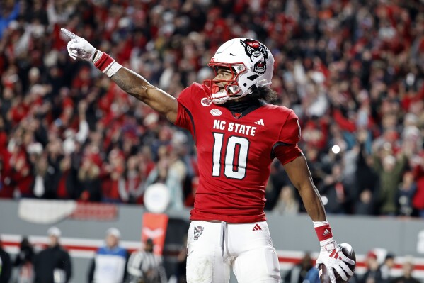 North Carolina State wide receiver Kevin Concepcion celebrates his touchdown against North Carolina during the first half of an NCAA college football game in Raleigh, N.C., Saturday, Nov. 25, 2023. (AP Photo/Karl B DeBlaker)