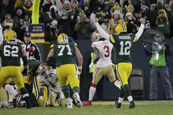 Green Bay Packers' Aaron Rodgers reacts after A.J. Dillon runs for a touchdown during the first half of an NFC divisional playoff NFL football game against the San Francisco 49ers Saturday, Jan. 22, 2022, in Green Bay, Wis. (AP Photo/Aaron Gash)