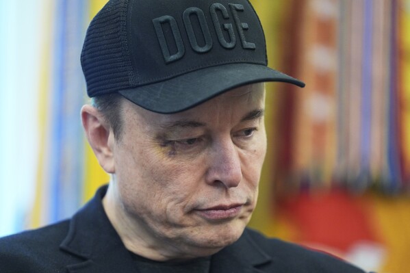 Elon Musk attends news conference with President Donald Trump in the Oval Office of the White House, Friday, May 30, 2025, in Washington. (AP Photo/Evan Vucci)