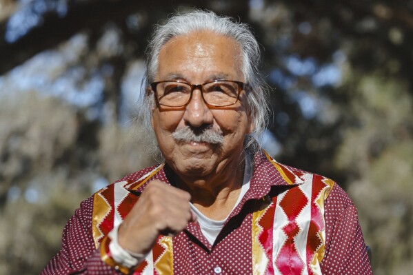 In this photo released by NDN Collective, Native American activist Leonard Peltier poses for pictures as he was released from a Florida prison on Tuesday, Feb. 18, 2025, weeks after then-President Joe Biden angered law enforcement officials by commuting his life sentence to home confinement in the 1975 killings of two FBI agents. (Angel White Eyes, NDN Collective via AP)