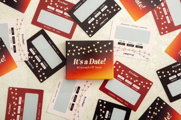 This product image shows the card game It’s a Date! with scratch-off date ideas for couples. Interactive card games are good options for holiday gifts. (It’s a Date! via AP)